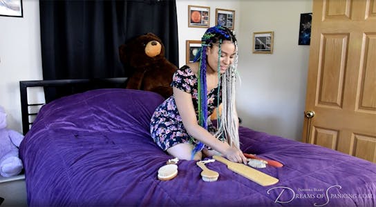 Jayda Blaze organizes her floggers in a Dreams of Spanking video