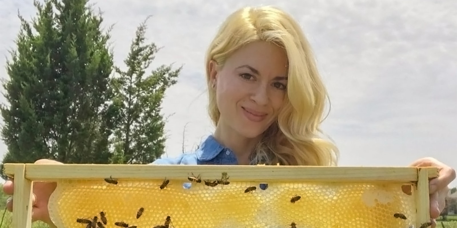 woman holding bee comb