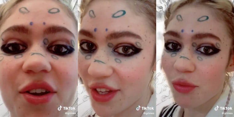 Grimes with pen all over her face