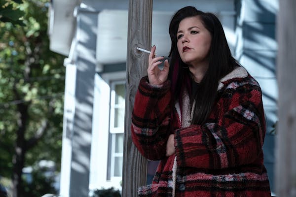 woman on porch smoking a cigarette