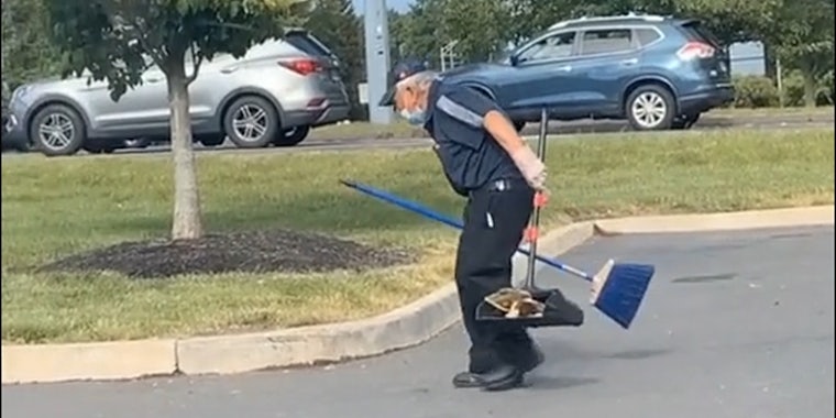 man cleaning up mcdonalds parking lot