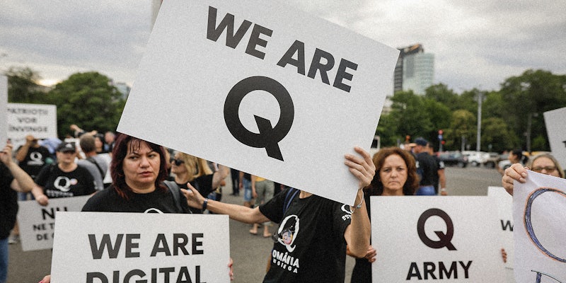Q Anon supporters with signs.