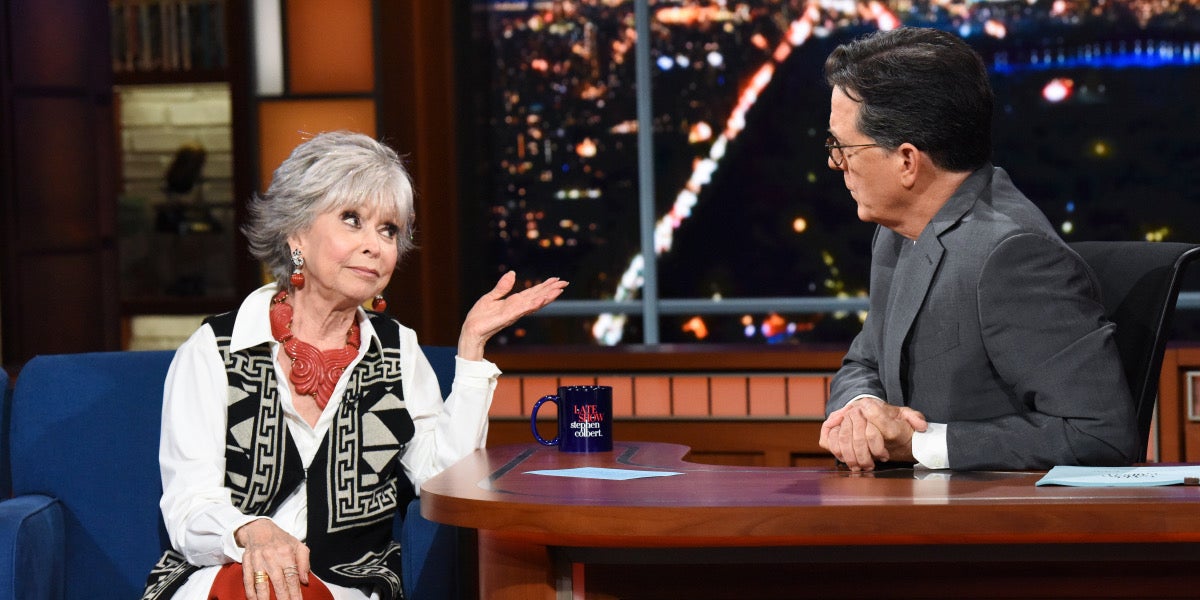 rita moreno (left) talking to stephen colbert