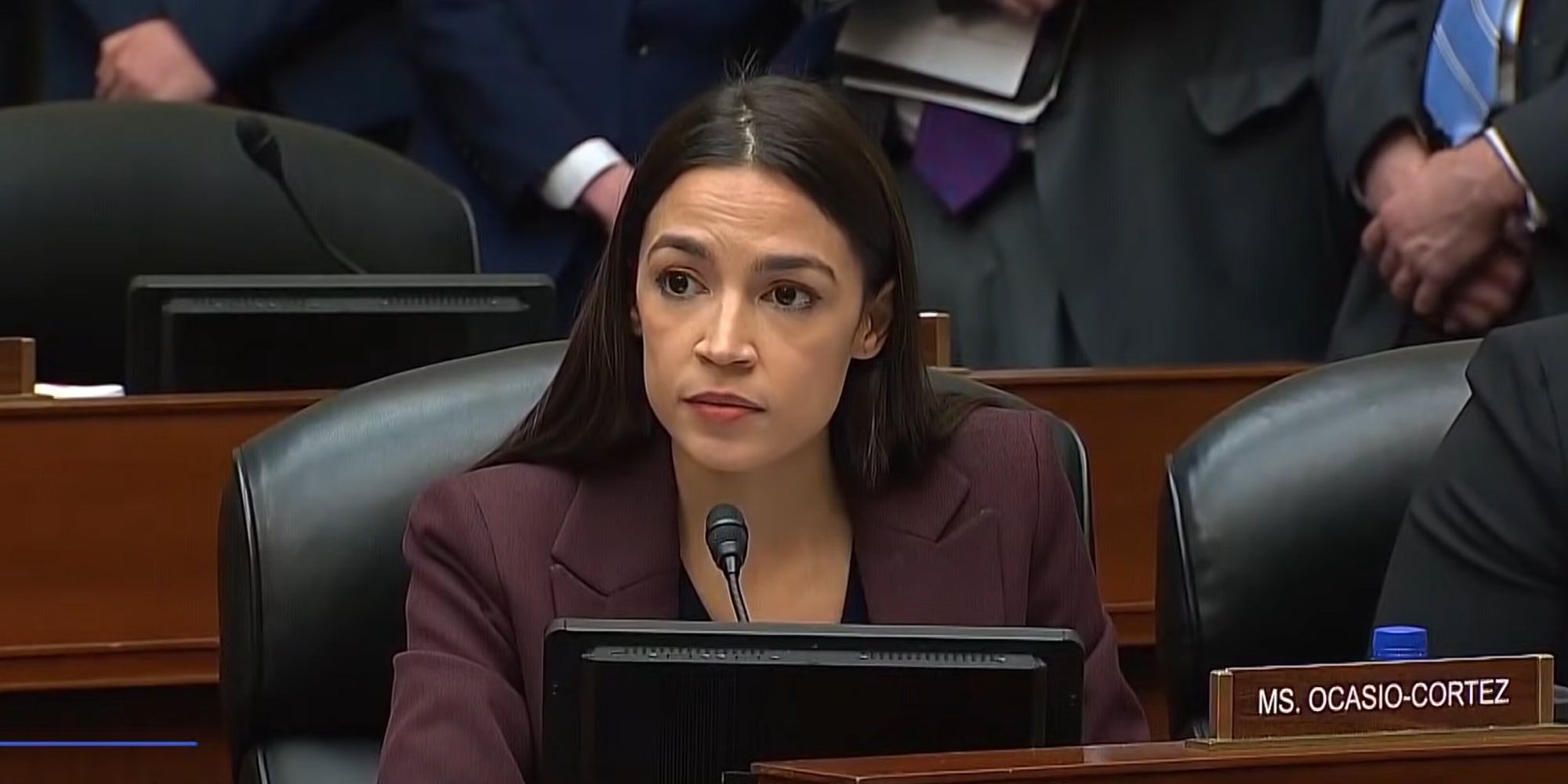 Rep. Alexandria Ocasio-Cortez (AOC) looking forward during a congressional hearing.