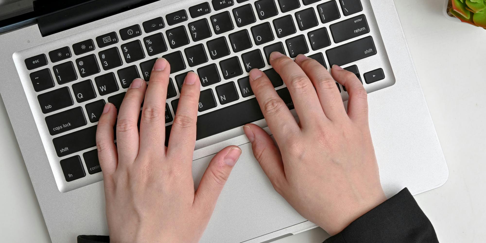 A person typing on a laptop.