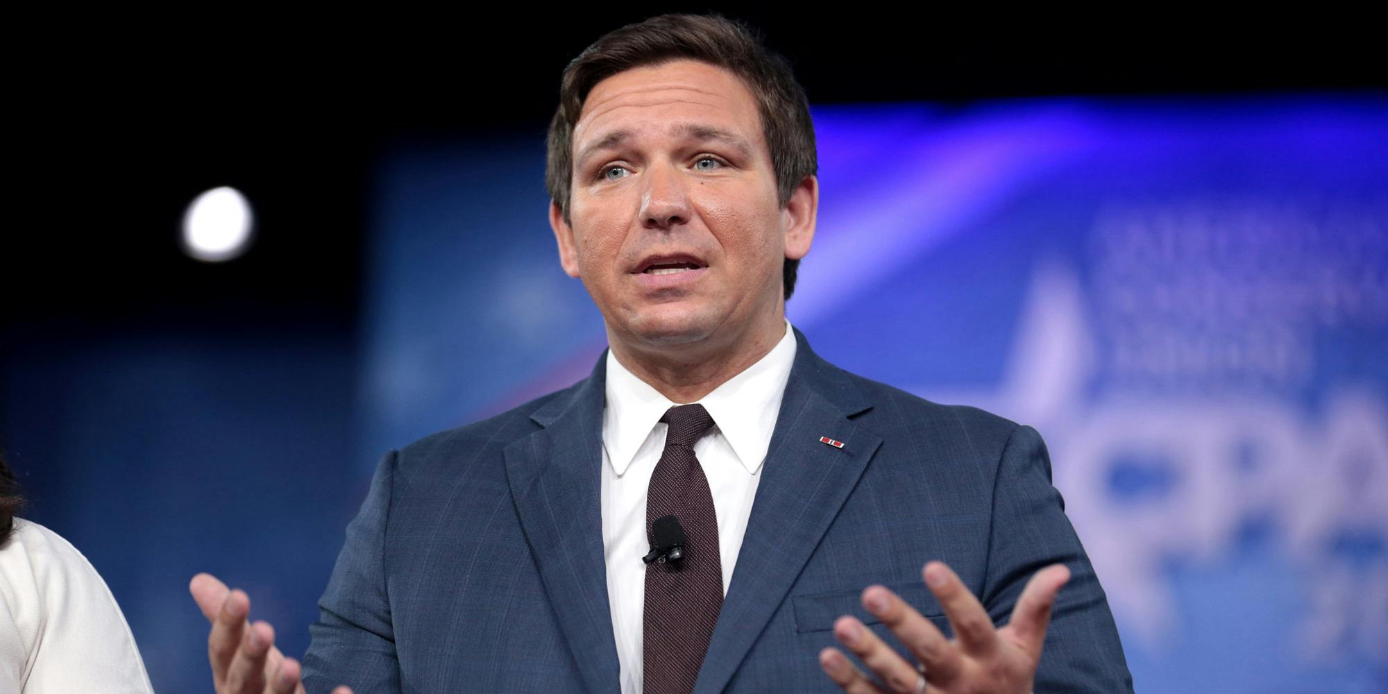 Florida Governor Ron DeSantis holding out his arms in a confused sort of way.