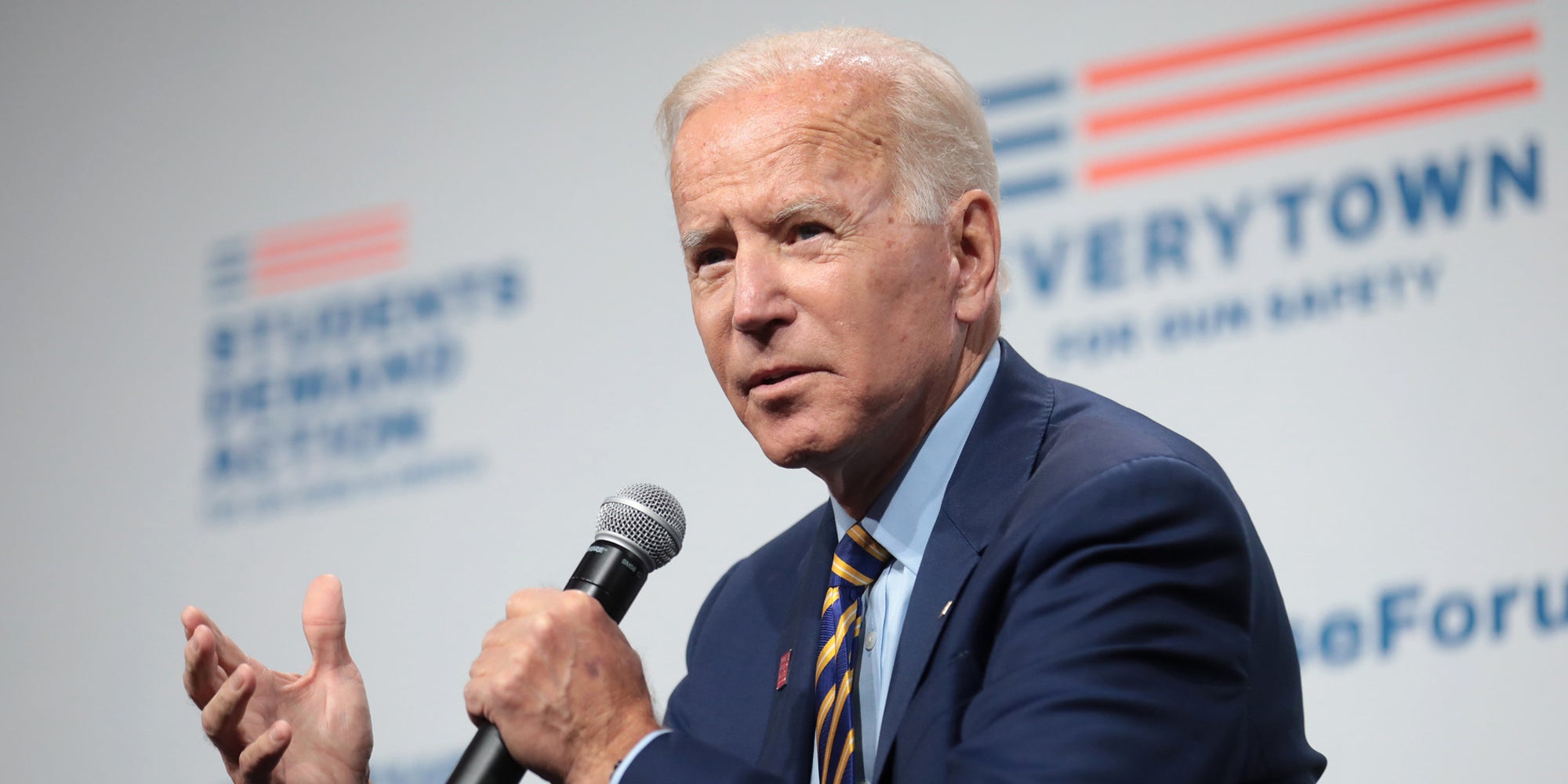 President Joe Biden speaking into a microphone.