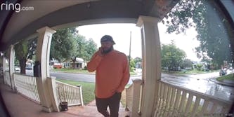 Ring doorbell camera screenshot of man walking up to porch of father in law's house as he calls him a "dickhead"