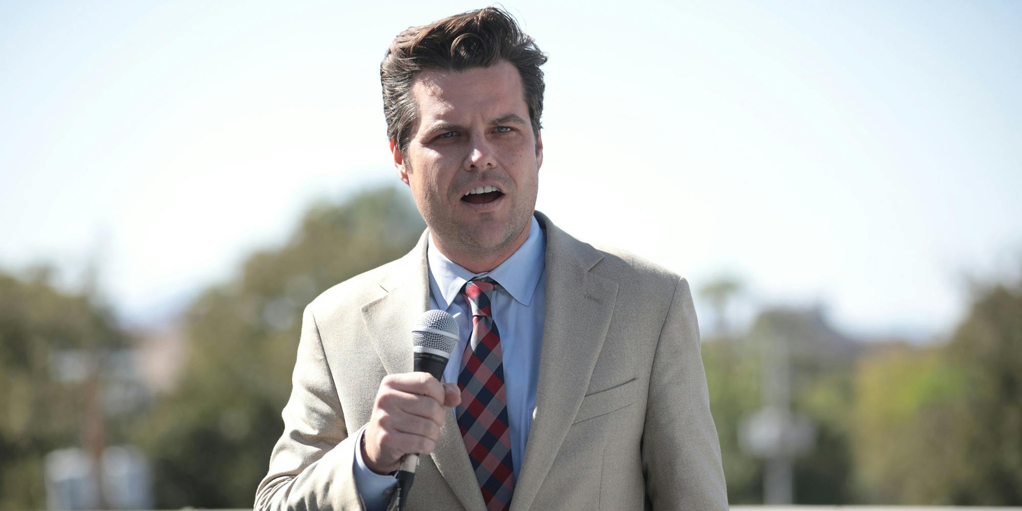 Rep. Matt Gaetz speaking into a microphone while give a speech outside.