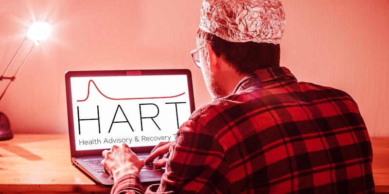 man with aluminum cap with HART Health Advisory & Recovery Team logo on laptop