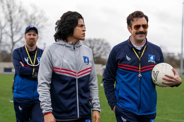 soccer player (center) and two coaches