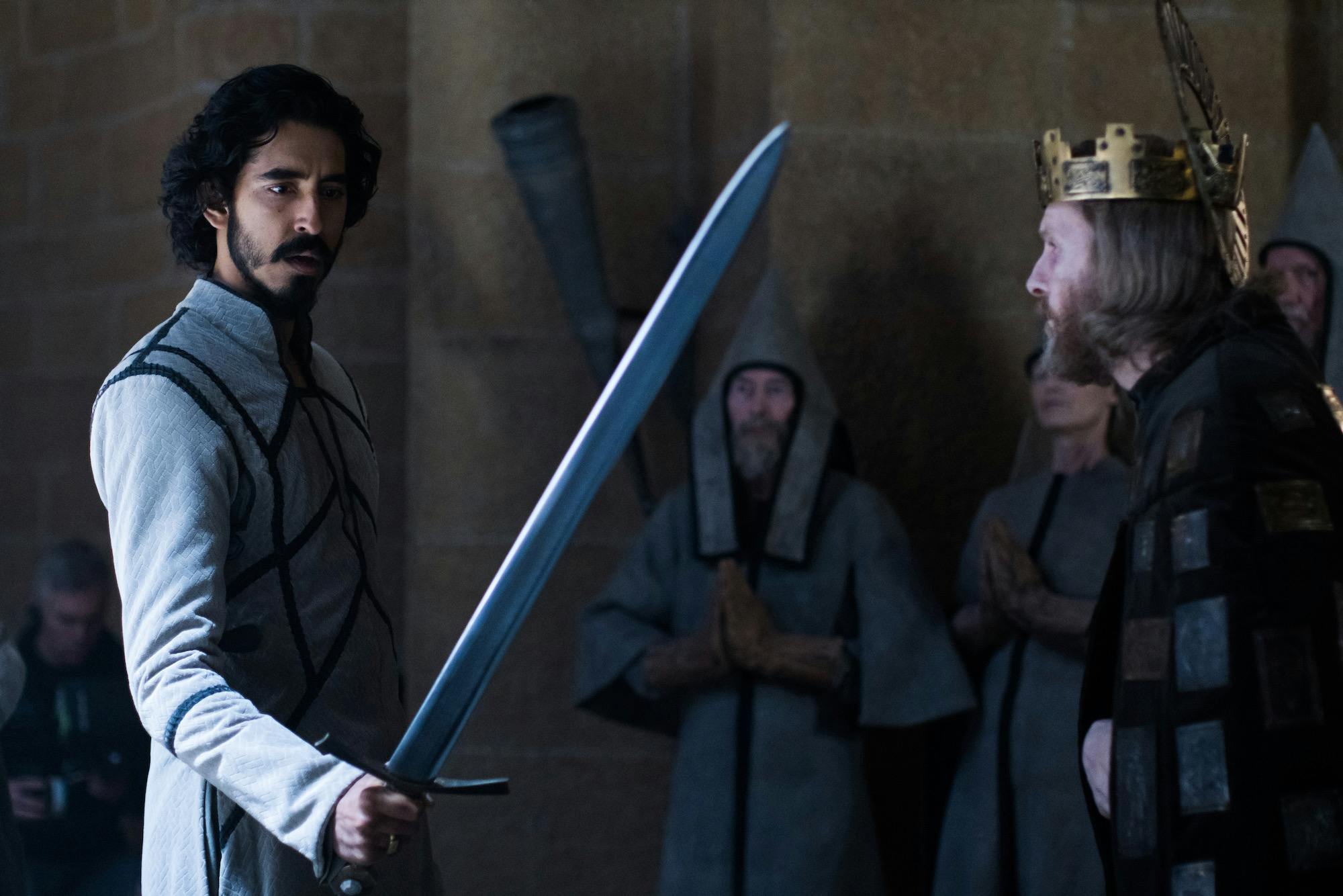 gawain (left) holding a sword as king arthur (right) looks on