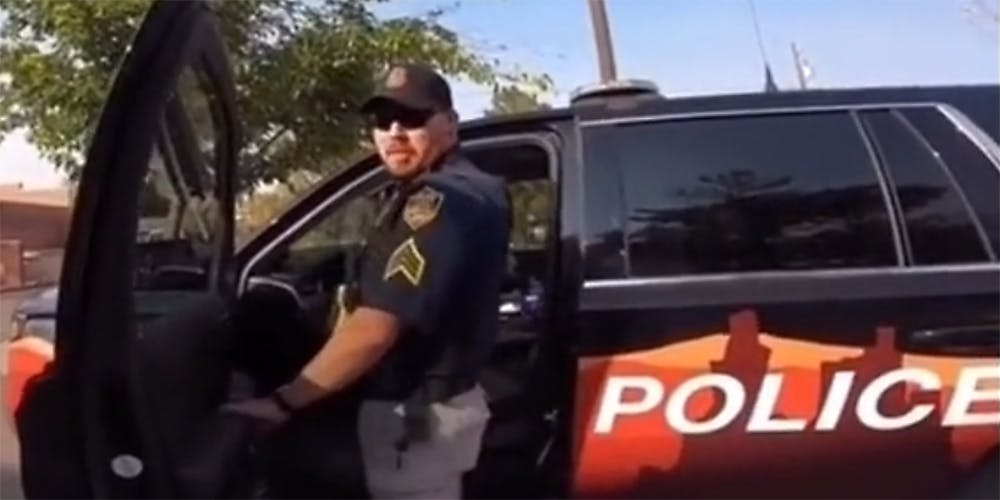 A cop getting in his car.