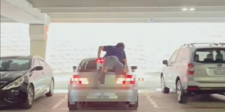 TikToker Dre uploaded a video showing the man climbing the back of a car