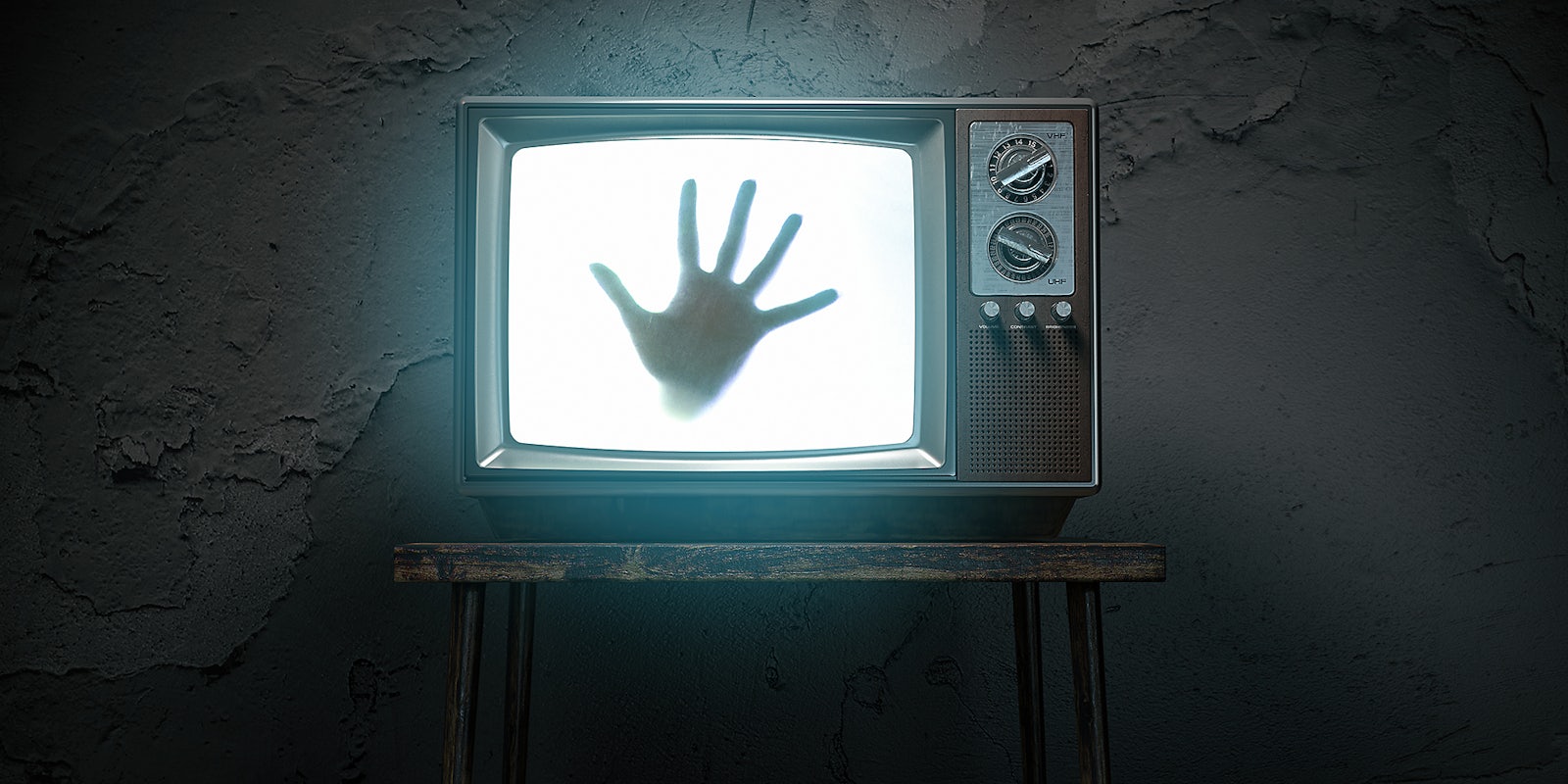 A hand coming out of a television.