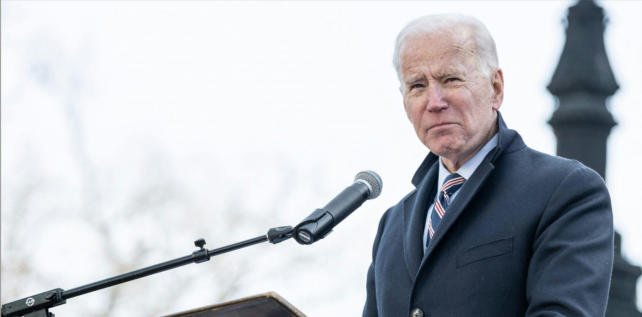 joe biden speaking at microphone