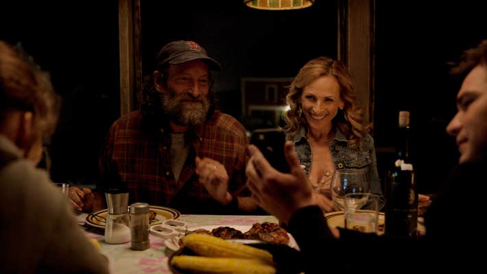two parents look at phone across the table