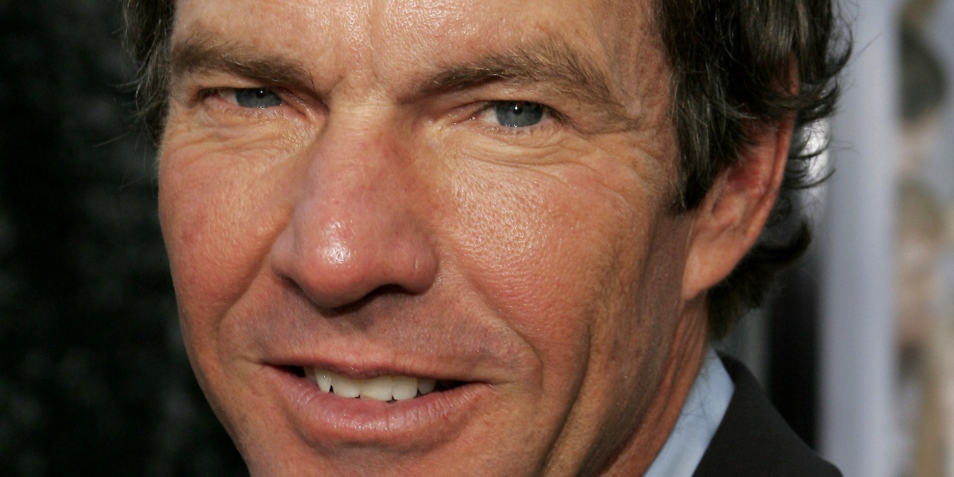 Dennis Quaid looking into camera.