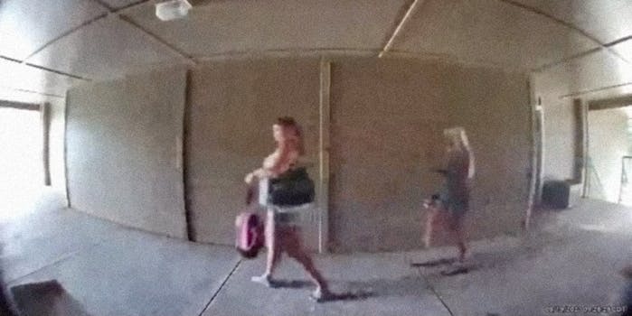 Two women walking down a hallway.
