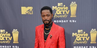 man in red suit on the red carpet