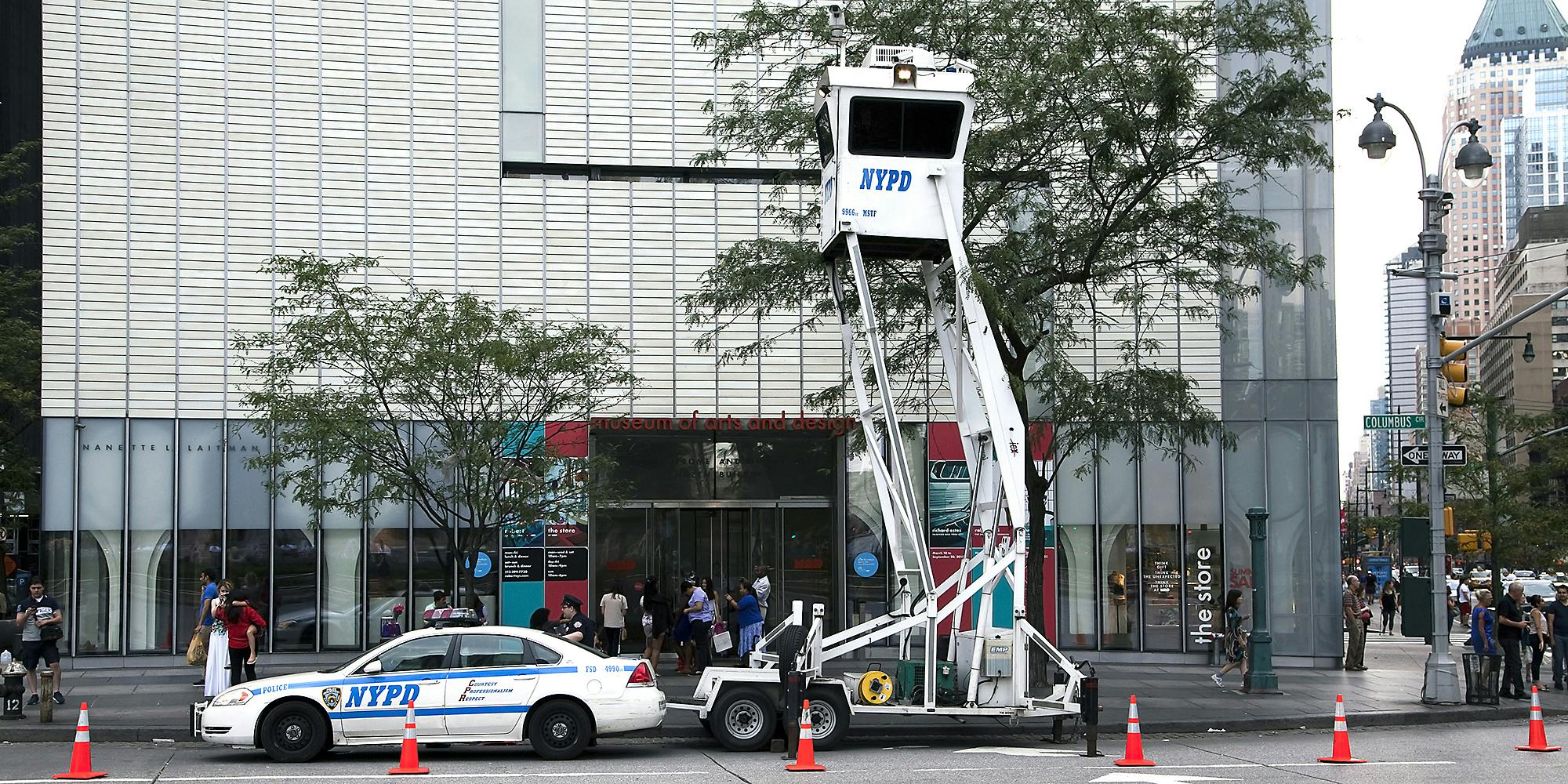 A NYPD car and surveillance tower.