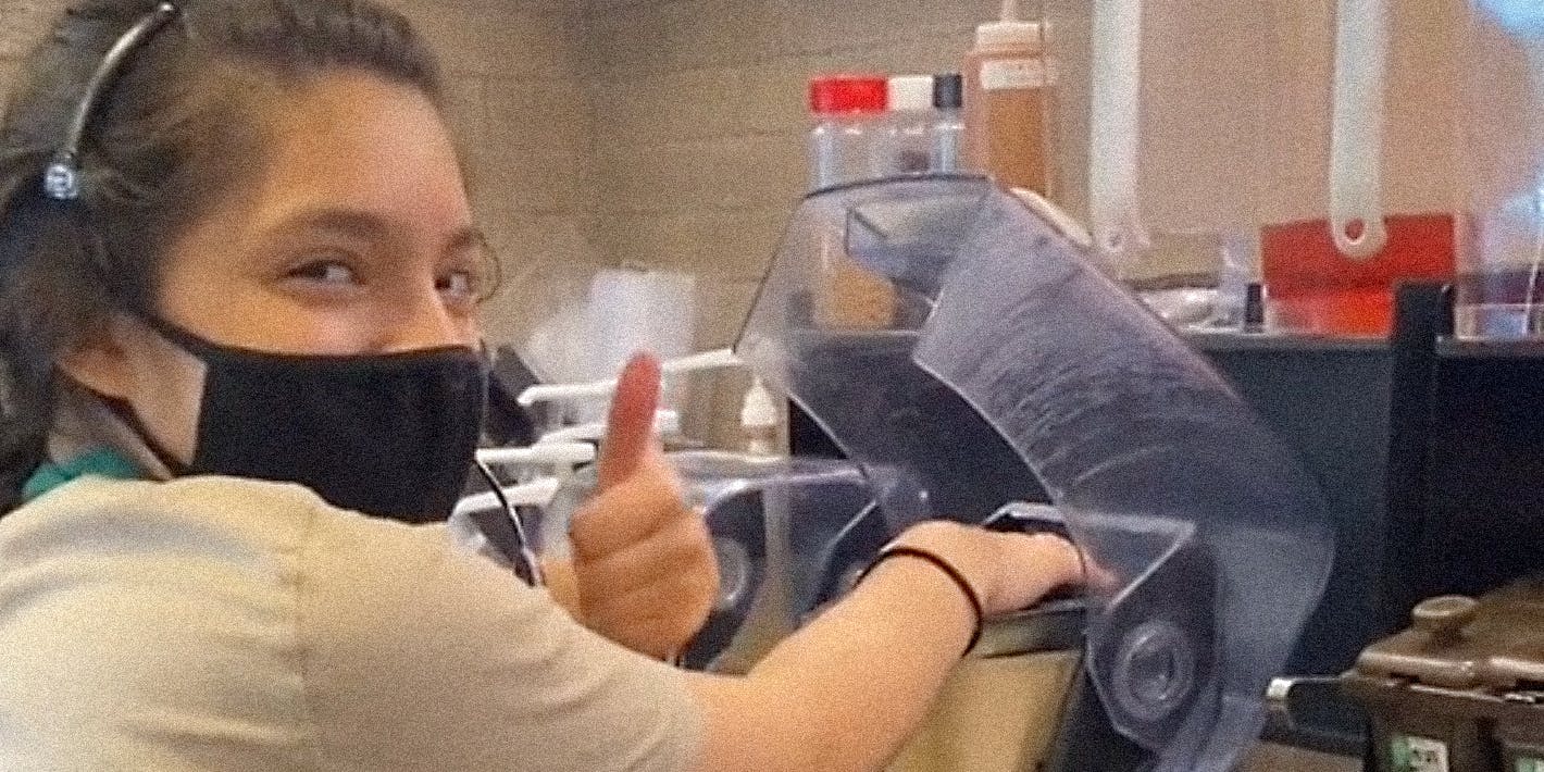 A Starbucks worker making drinks.