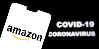 Amazon logo on a smartphone and Coronavirus COVID-19 words on blurred background.