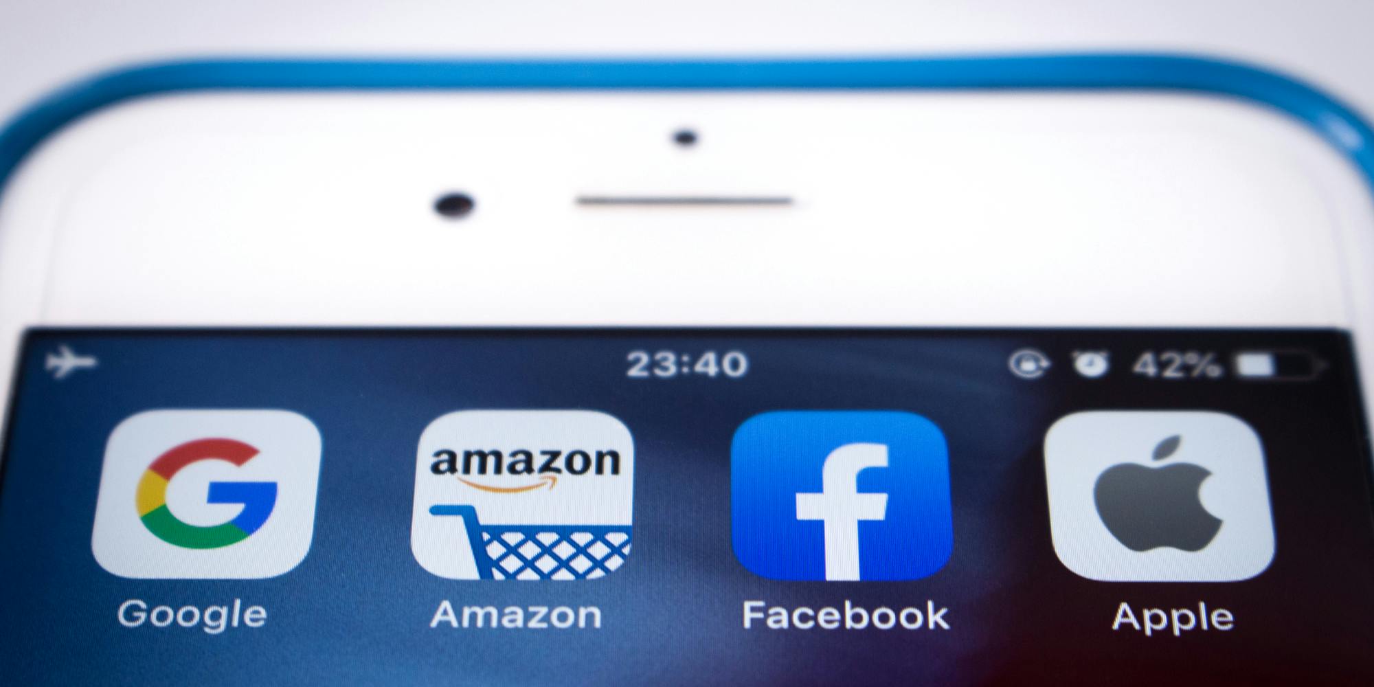 A phone showing apps for big tech companies including Google, Amazon, Facebook, and Apple.