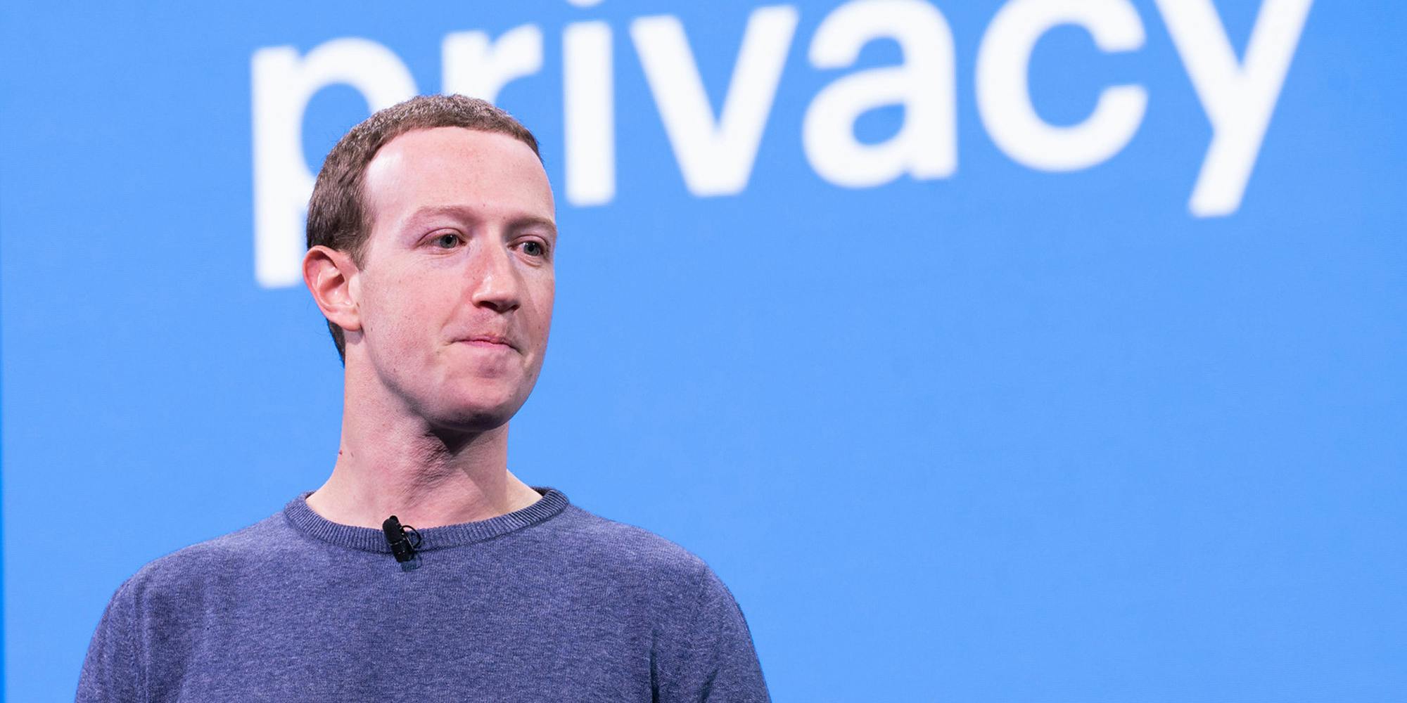 Facebook CEO Mark Zuckerberg standing in front of a sign that says 'privacy.'