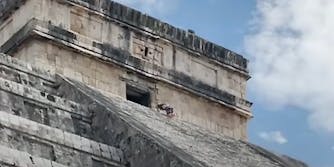 A person climbing a temple.