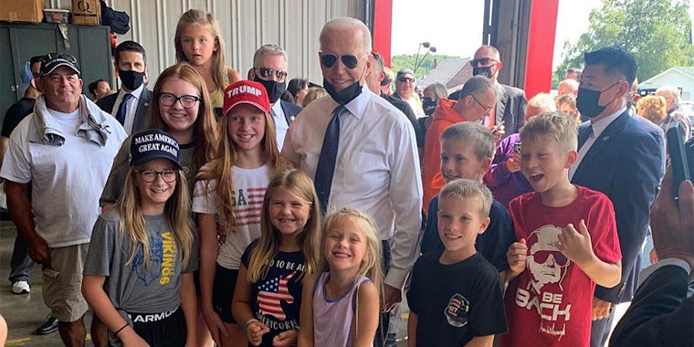 Joe Biden with children wearing MAGA clothing