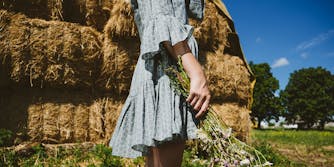 A girl wearing a dress on a farm.