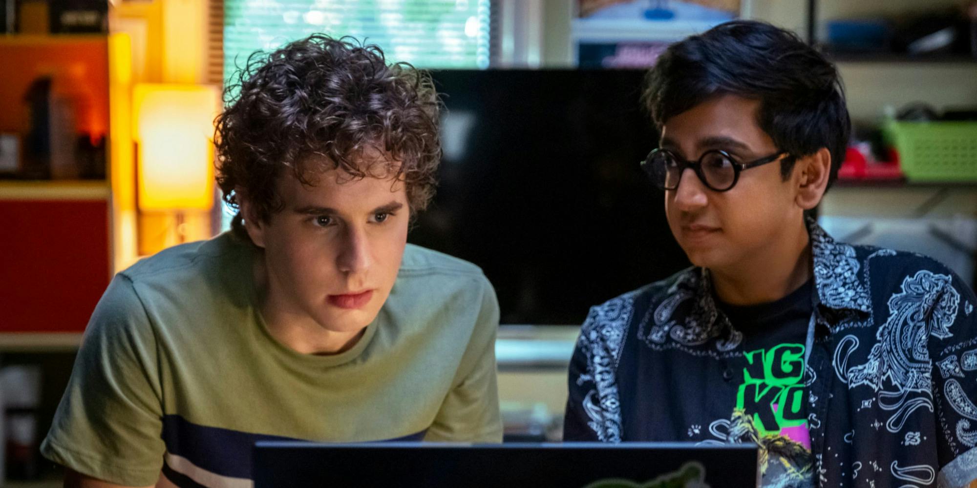 two people sitting in front of a computer