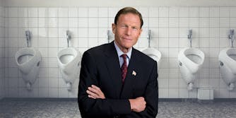 A man in front of urinals.