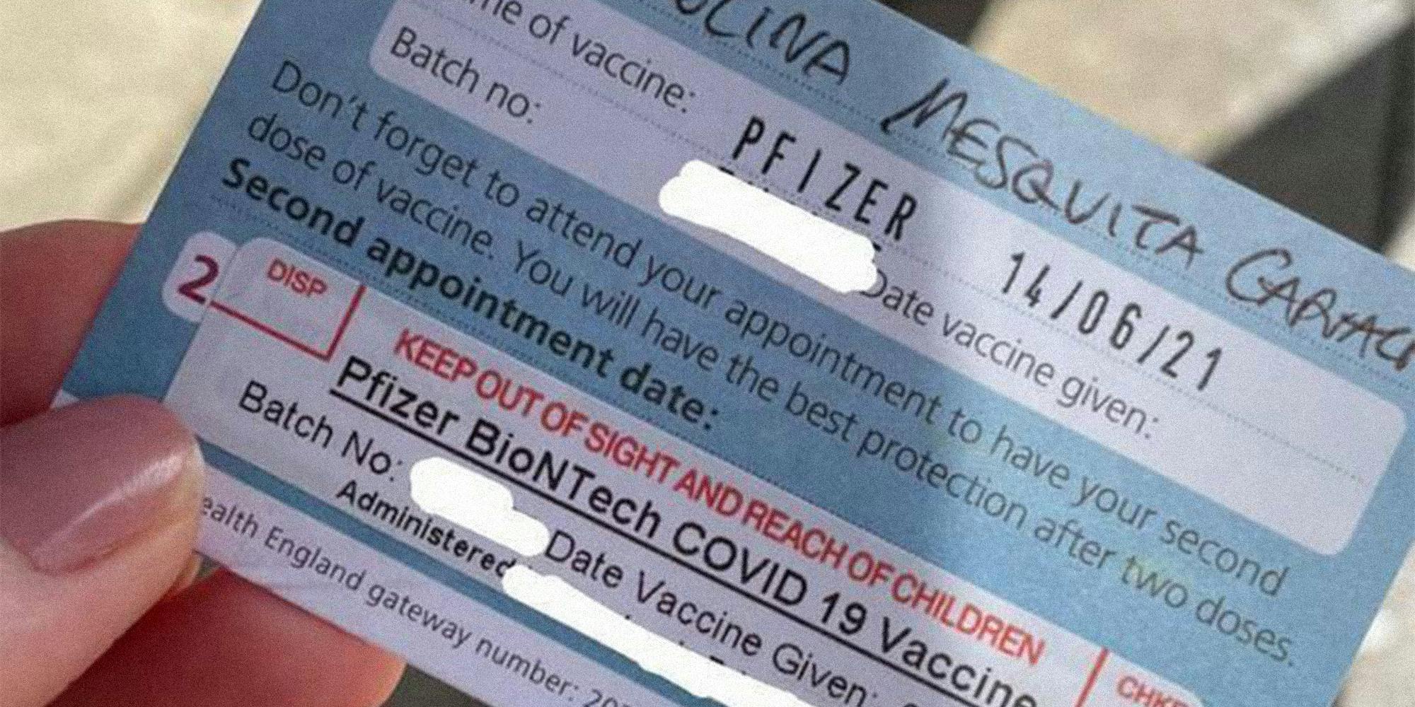 Hand holding vaccine card