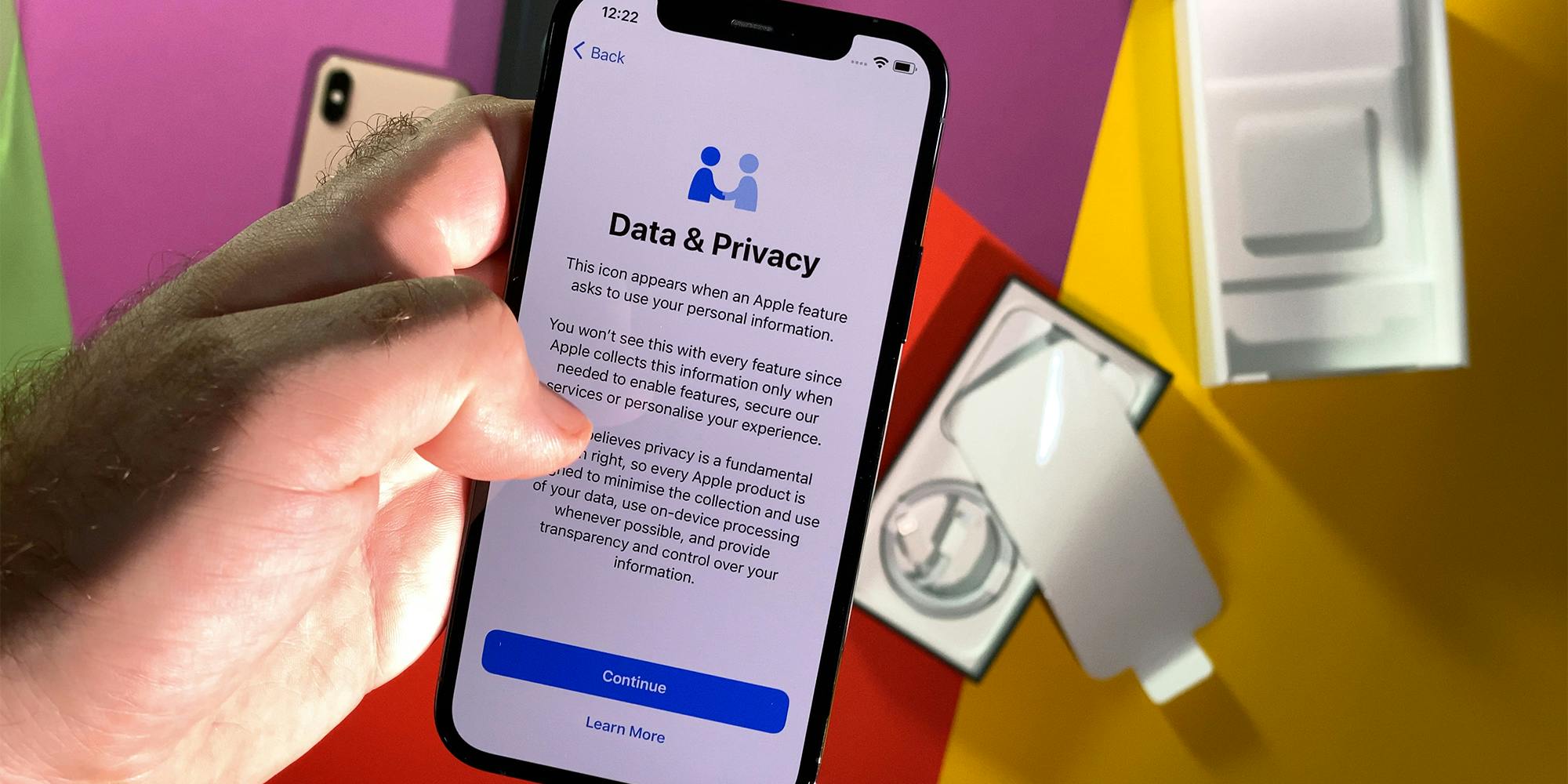POV male hand setting new iPhone 12 Pro latest smartphone with 5g reading about data and Privacy during setup