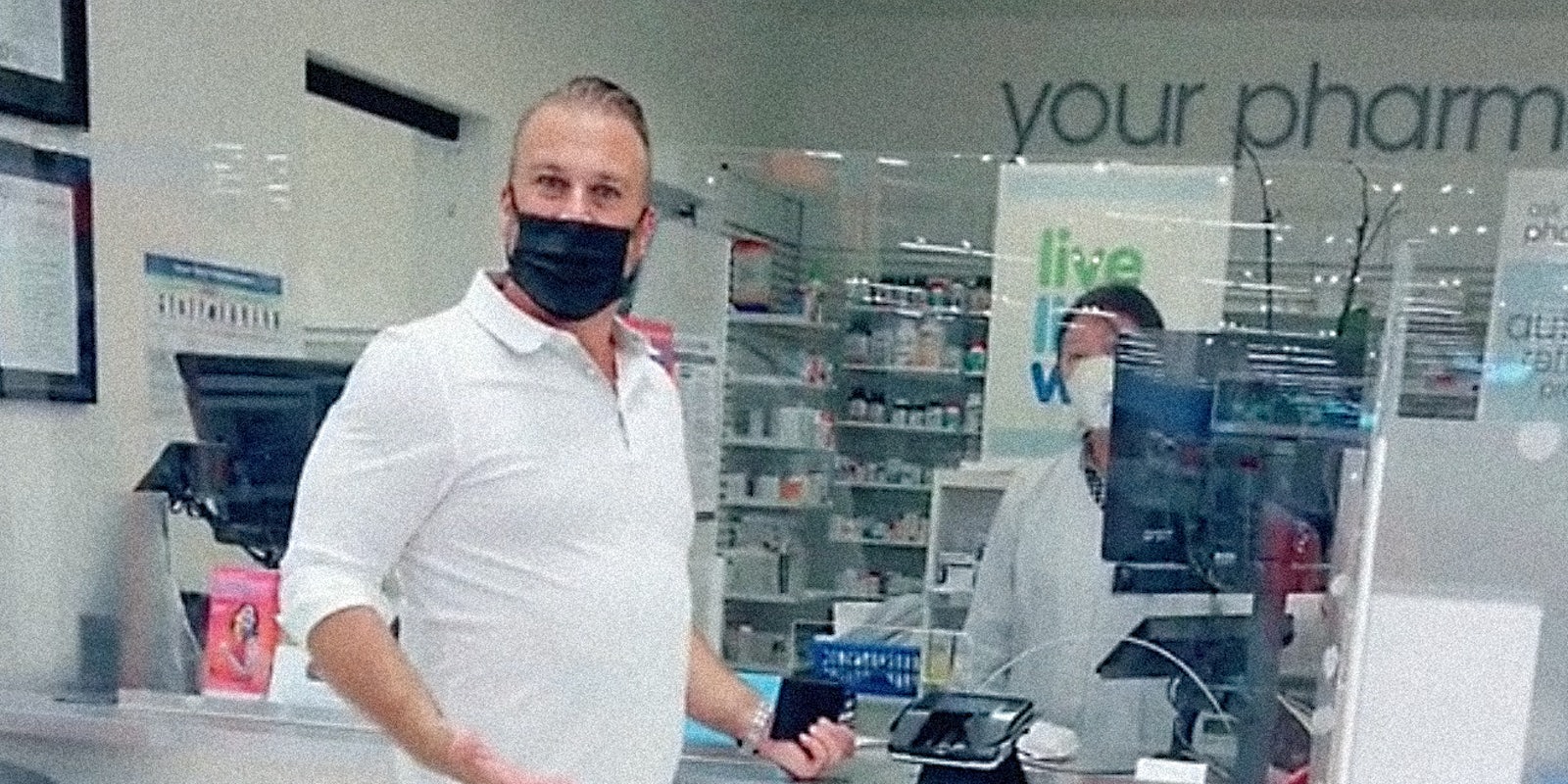 A man at a pharmacy looking into camera.