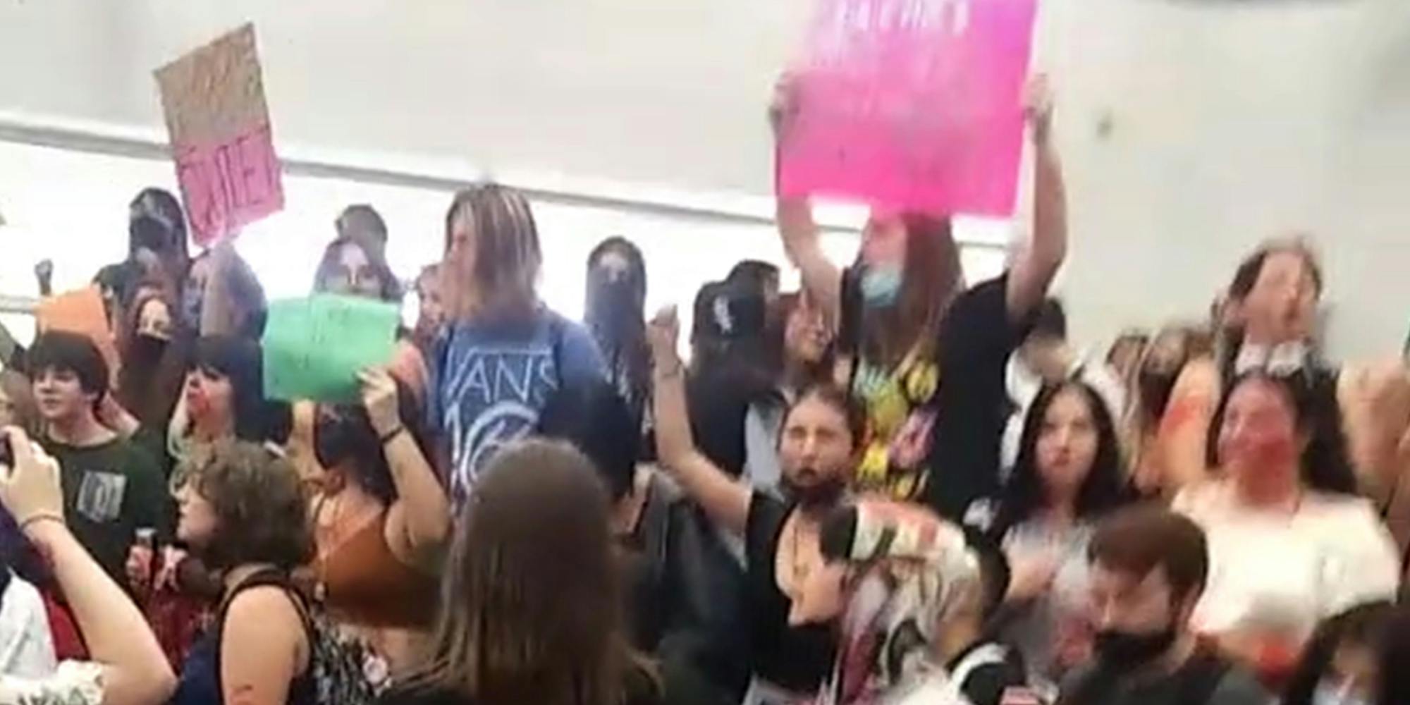 students holding protest signs