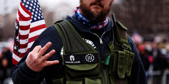 man with "Molon Labe" and 3% patch makes 3% hand sign at Trump rally
