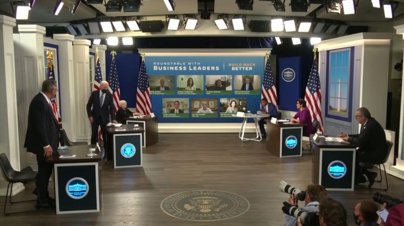 President Joe Biden hosting a meeting in the South Court Auditorium.