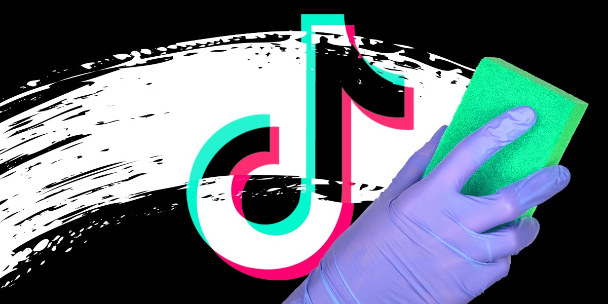 A person using a sponge to wipe grime off the TikTok logo.