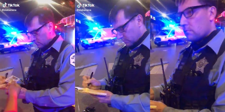 Police officer taking a woman's ID and writing in a notebook.