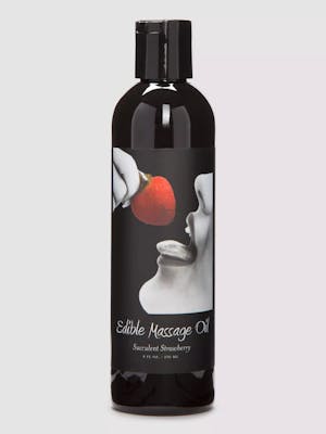 Black bottle of edible massage oil with woman eating a strawberry