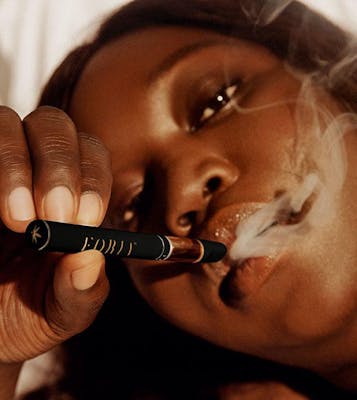 Woman inhaling Foria's CBD Intimacy Botanical Vape pen