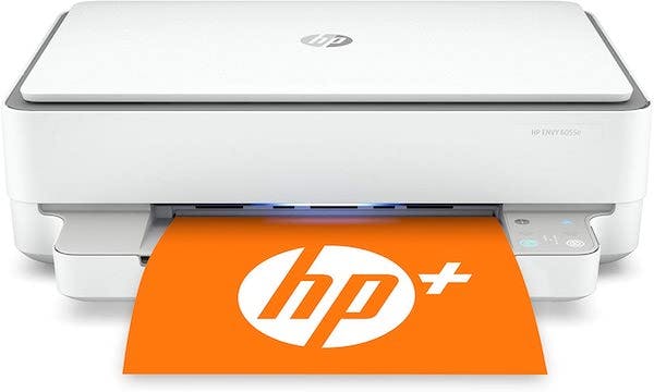 Sleek white and silver printer with orange paper sporting the HP logo