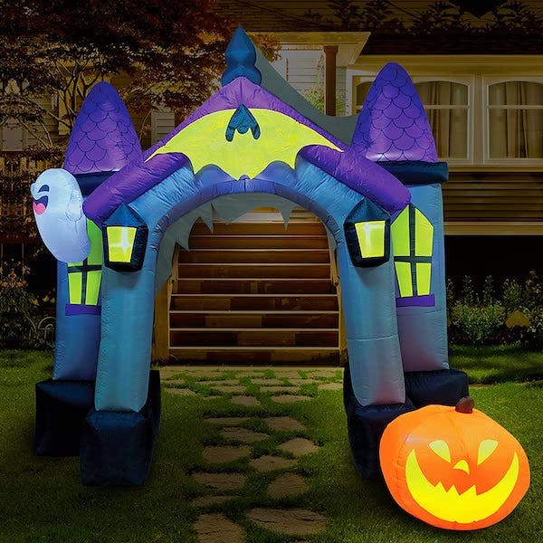 the best outdoor halloween decoration might be this inflatable haunted house with ghosts and pumpkins
