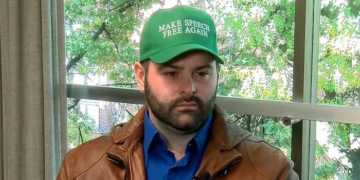 bearded man in "Make Speech Free Again" hat