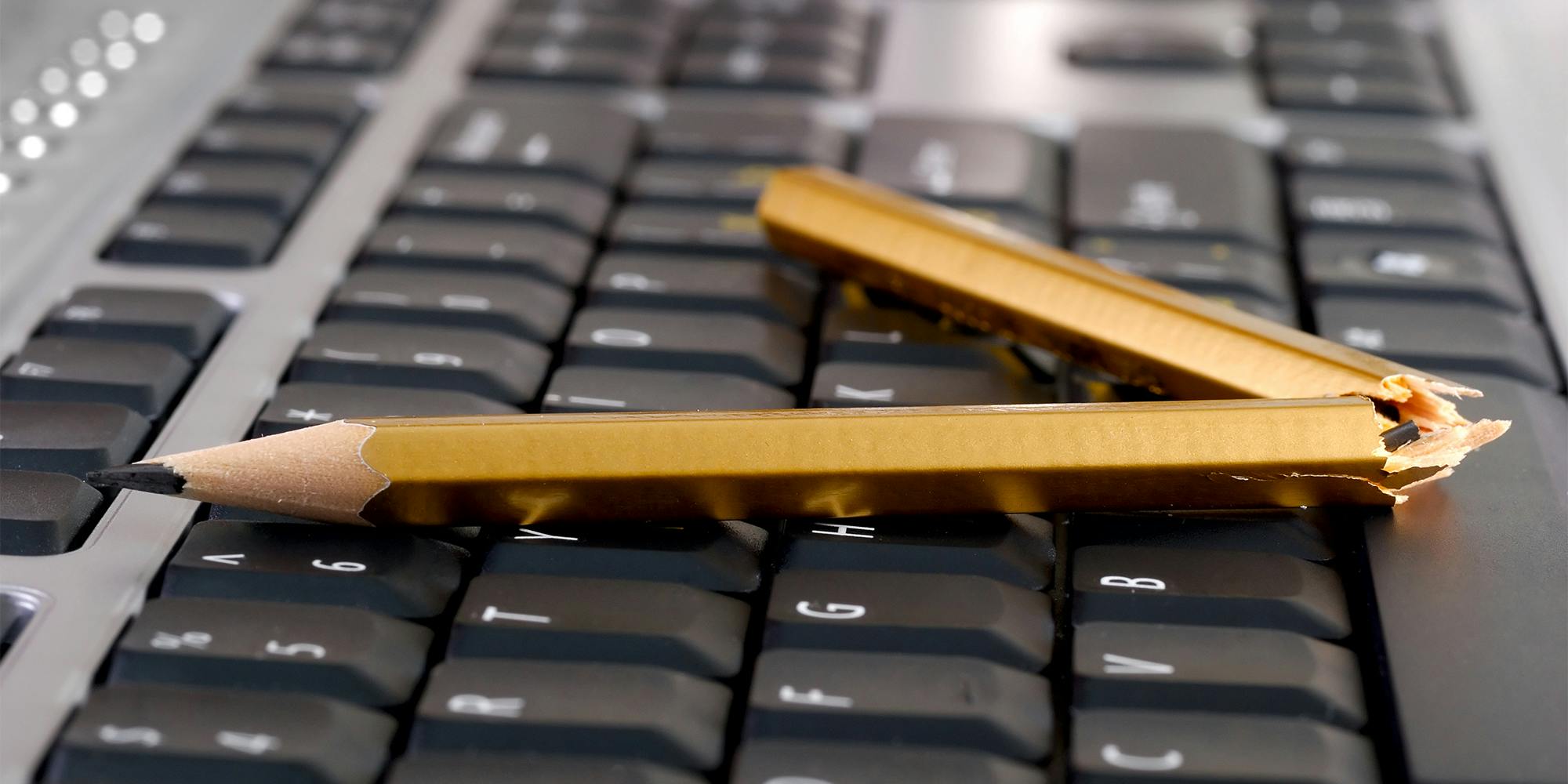 broken pencil on a keyboard