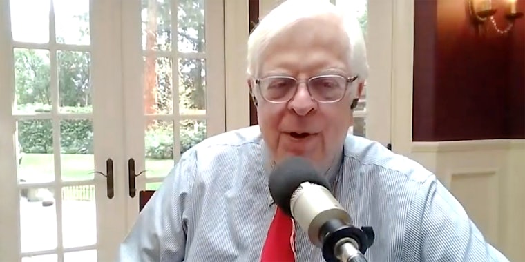 A man talking into a microphone at a residential home.