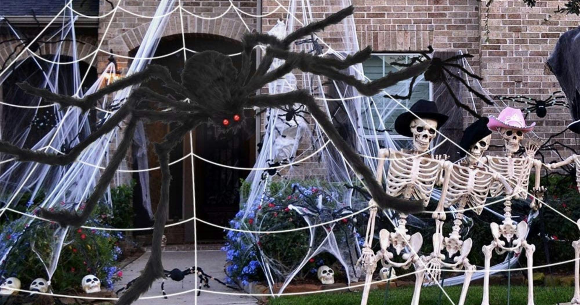 Best outdoor Halloween decorations featured - a house with skeletons and fake spiders surrounding it